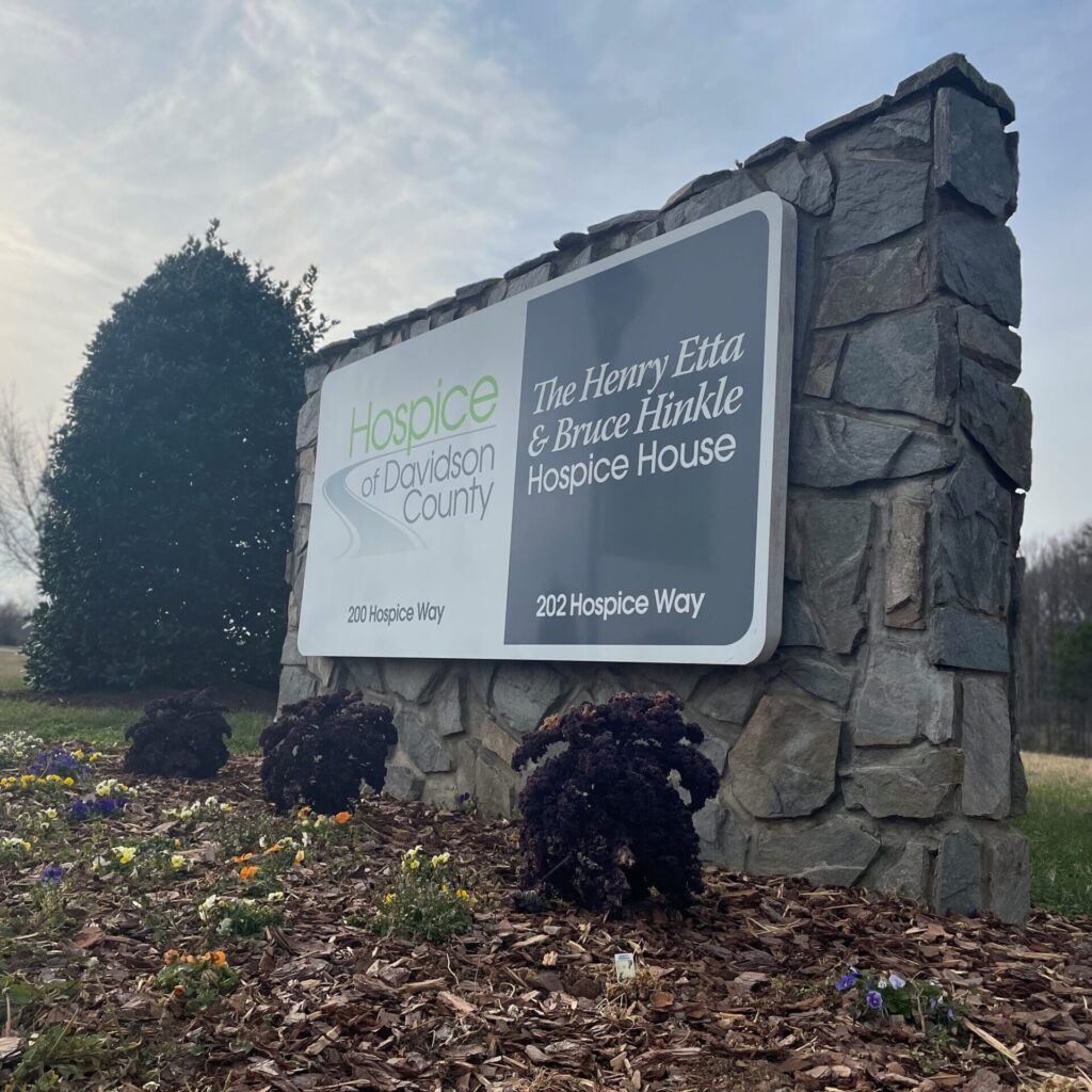sign for Henry Etta & Bruce Hinkle Hospice House on masonry