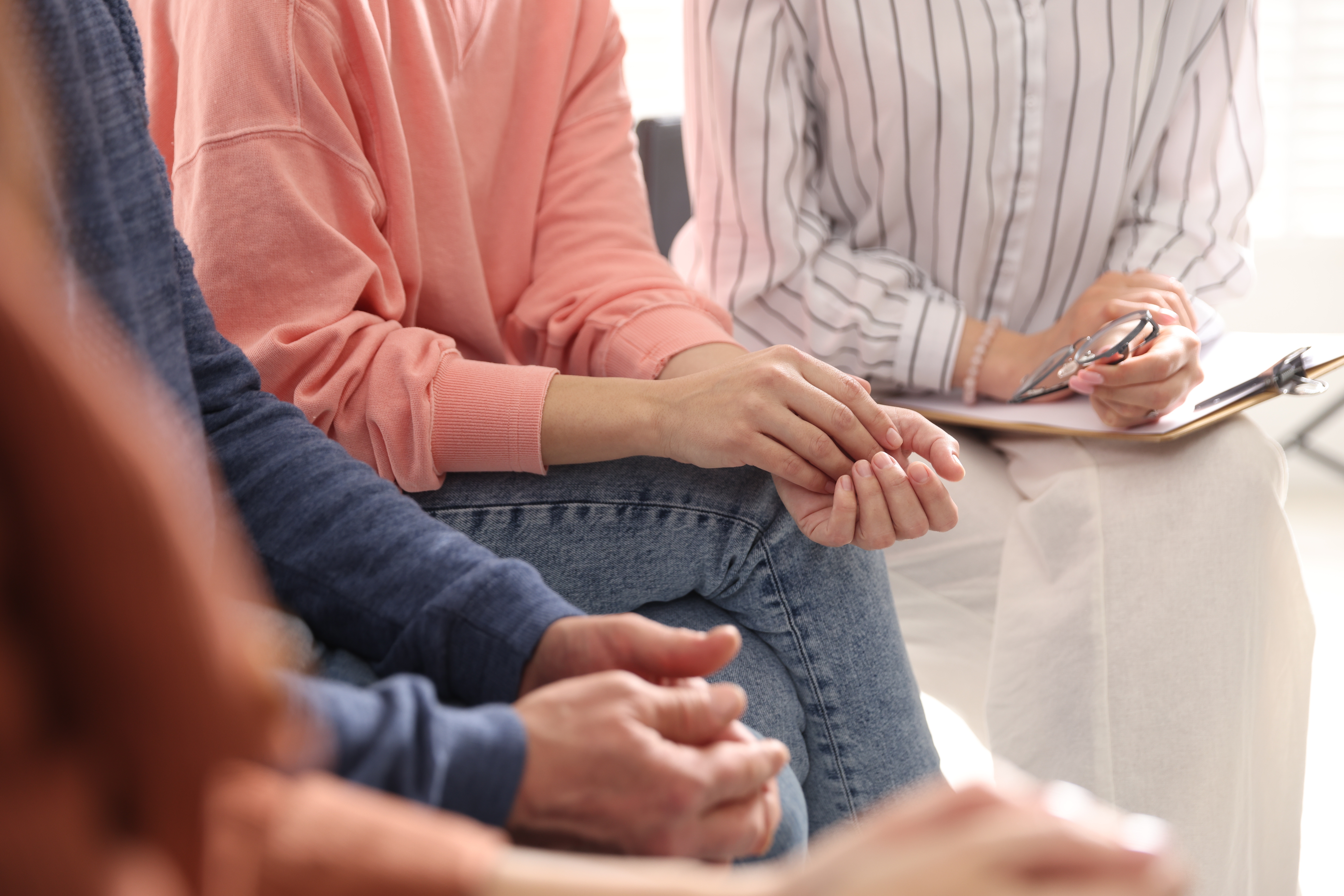 Group of people having psychotherapy session indoors, closeup