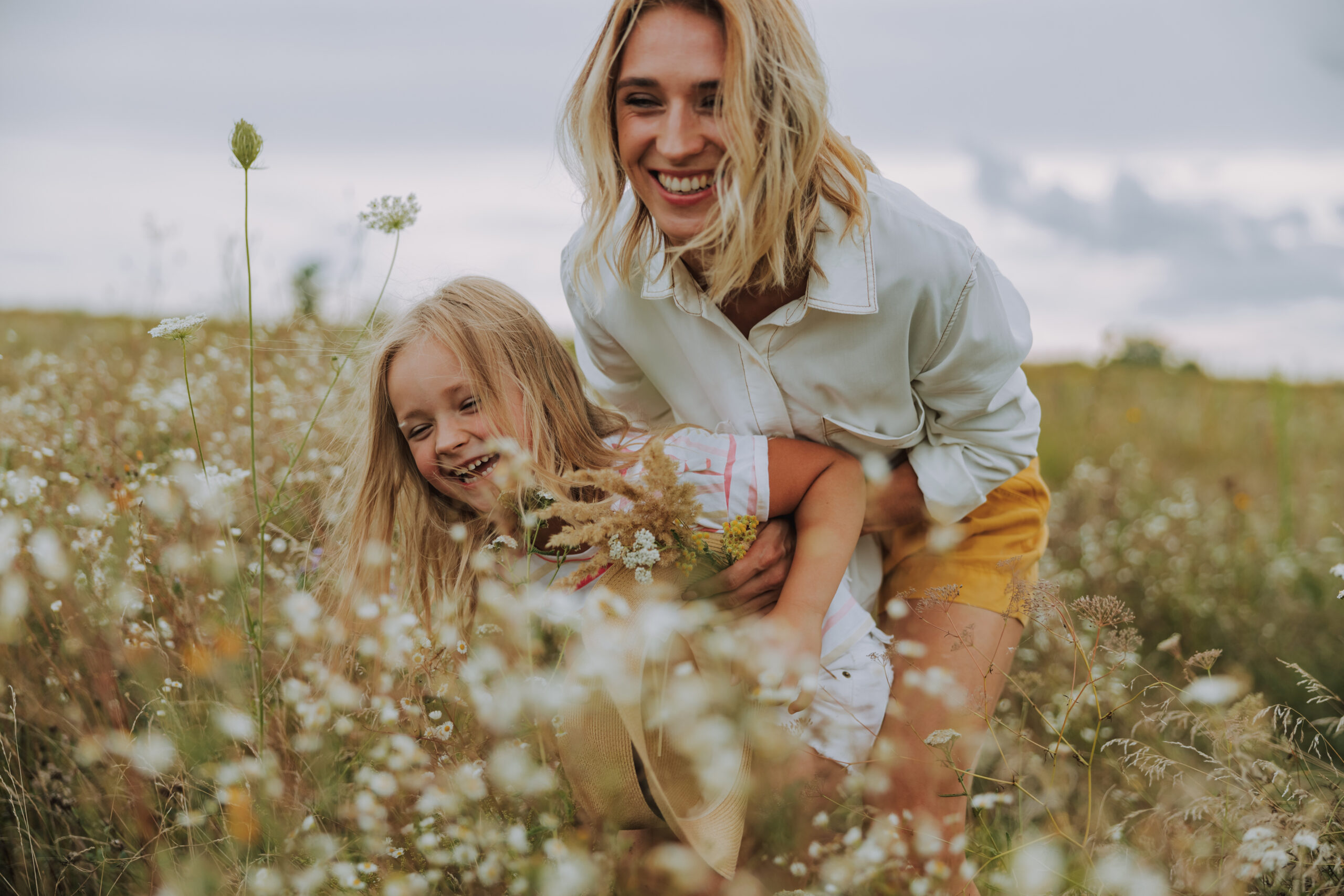 Smiling mother hugging her daughter stock photo