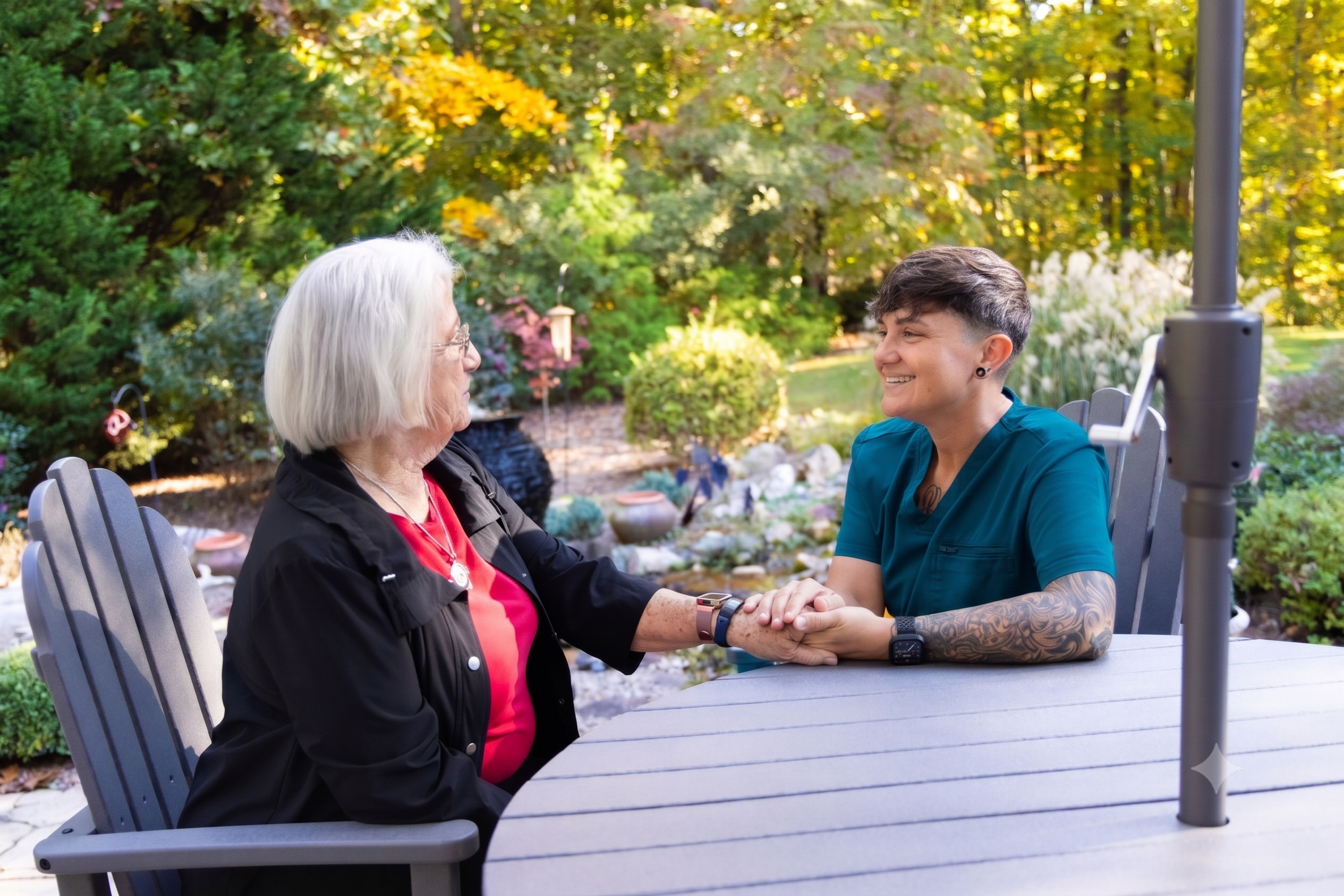 Professional caregiver holds an elderly woman's hand
