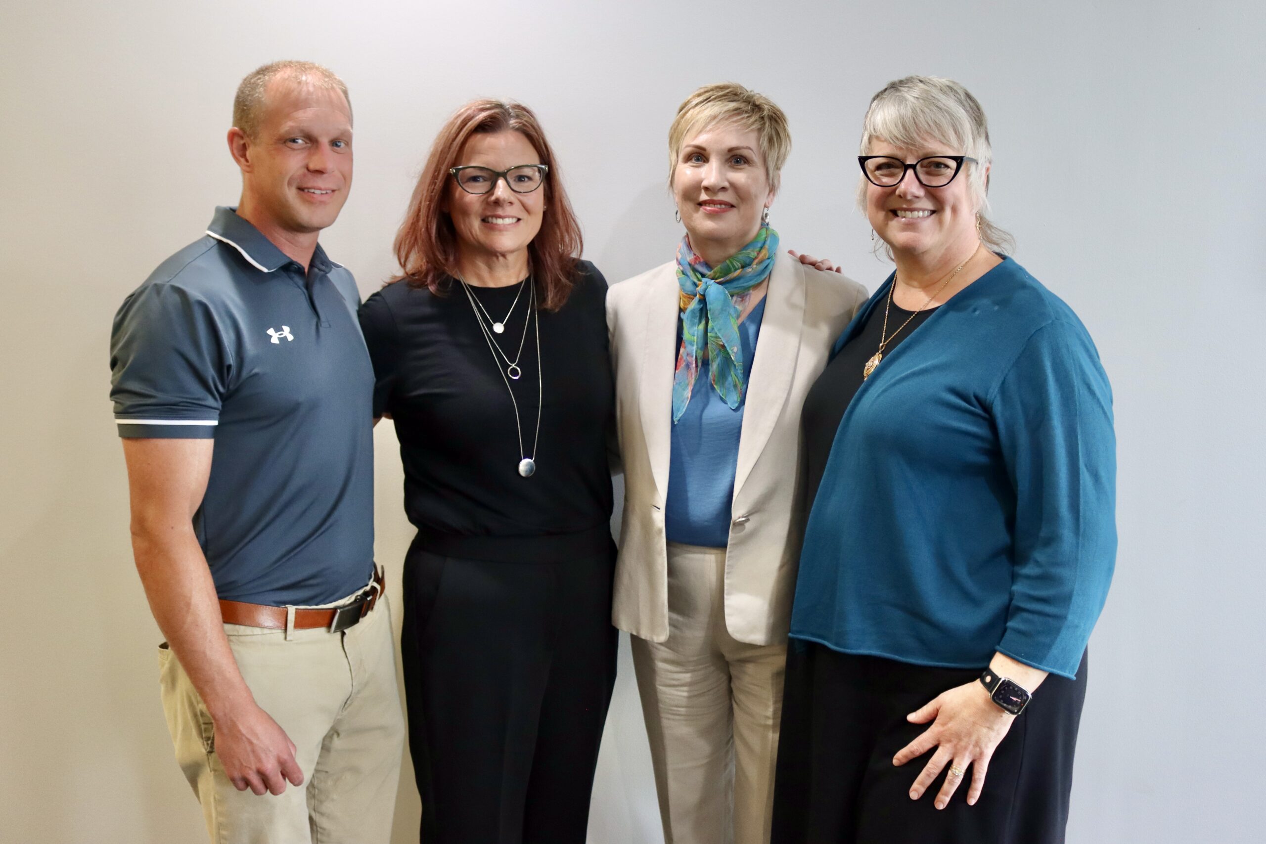 our Alderwood of Davidson County officers smiling together for a group photo against a neutral background, dressed in business and business-casual attire.
